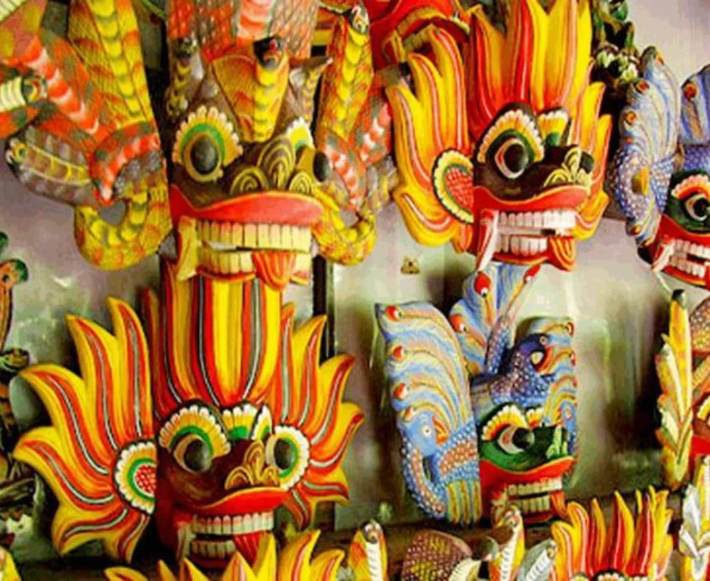 A close-up display of brightly colored, hand-carved traditional Sri Lankan wooden masks, which are a popular cultural souvenir. Discovering these unique crafts is a highlight of cultural tours arranged by Tour Operators in Sri Lanka and a professional Tour Company in Sri Lanka.