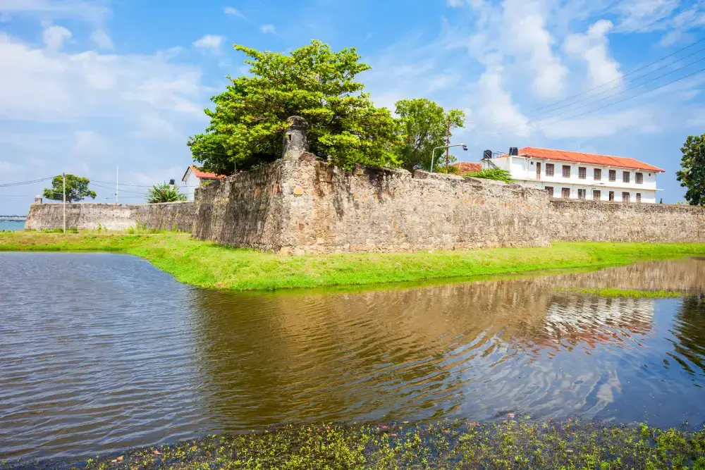 A stone fortress wall and a moat, representing the historic and cultural tours of ancient sites offered by a leading Tour Operators in Sri Lanka and Tour Company in Sri Lanka.