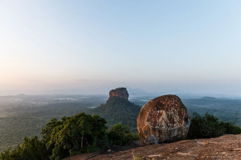 The stunning view of Sigiriya Rock Fortress and the surrounding jungle landscape, as seen from Pidurangala Rock, a popular trekking destination offered by Ceylon Roots, one of the leading Tour Operators in Sri Lanka and a top Tour Company in Sri Lanka.